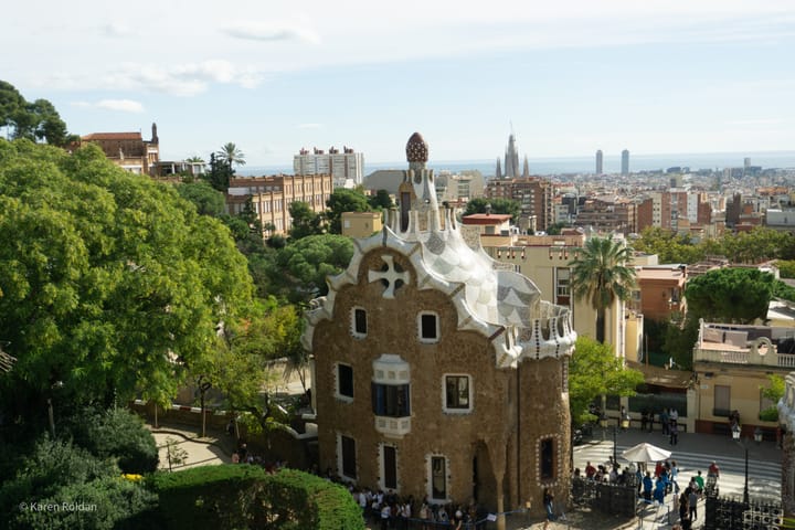 The mosaic-tiled Gingerbread House (Porter's Lodge) at the main entrance of Park Güell, designed by Antoni Gaudí.